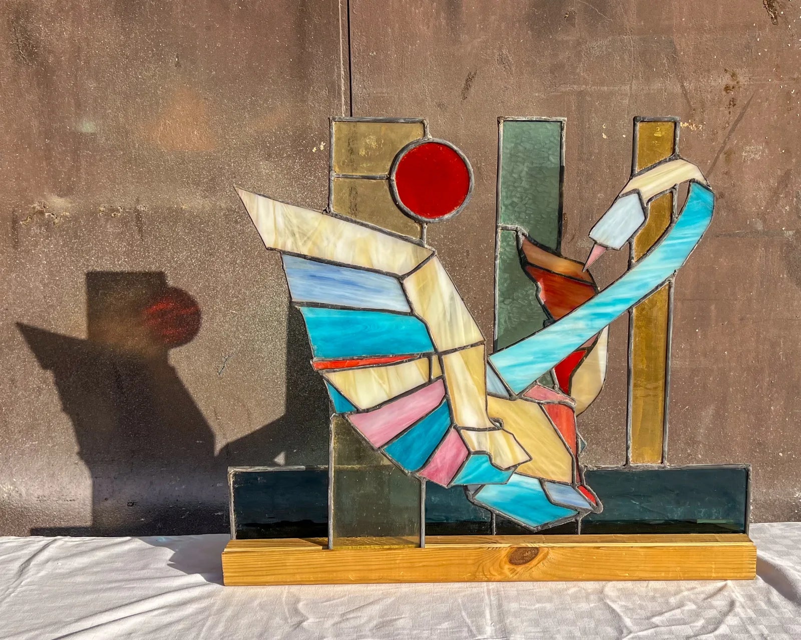 Geometric glass assemblage with a red circular form