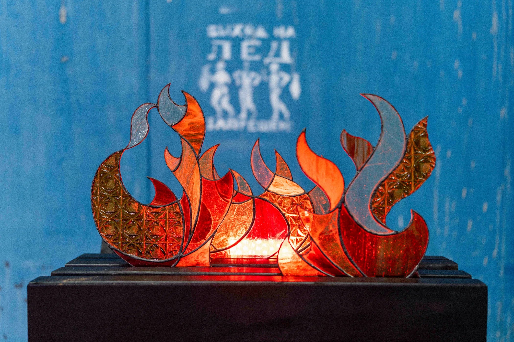 Illuminated red and amber stained-glass installation
