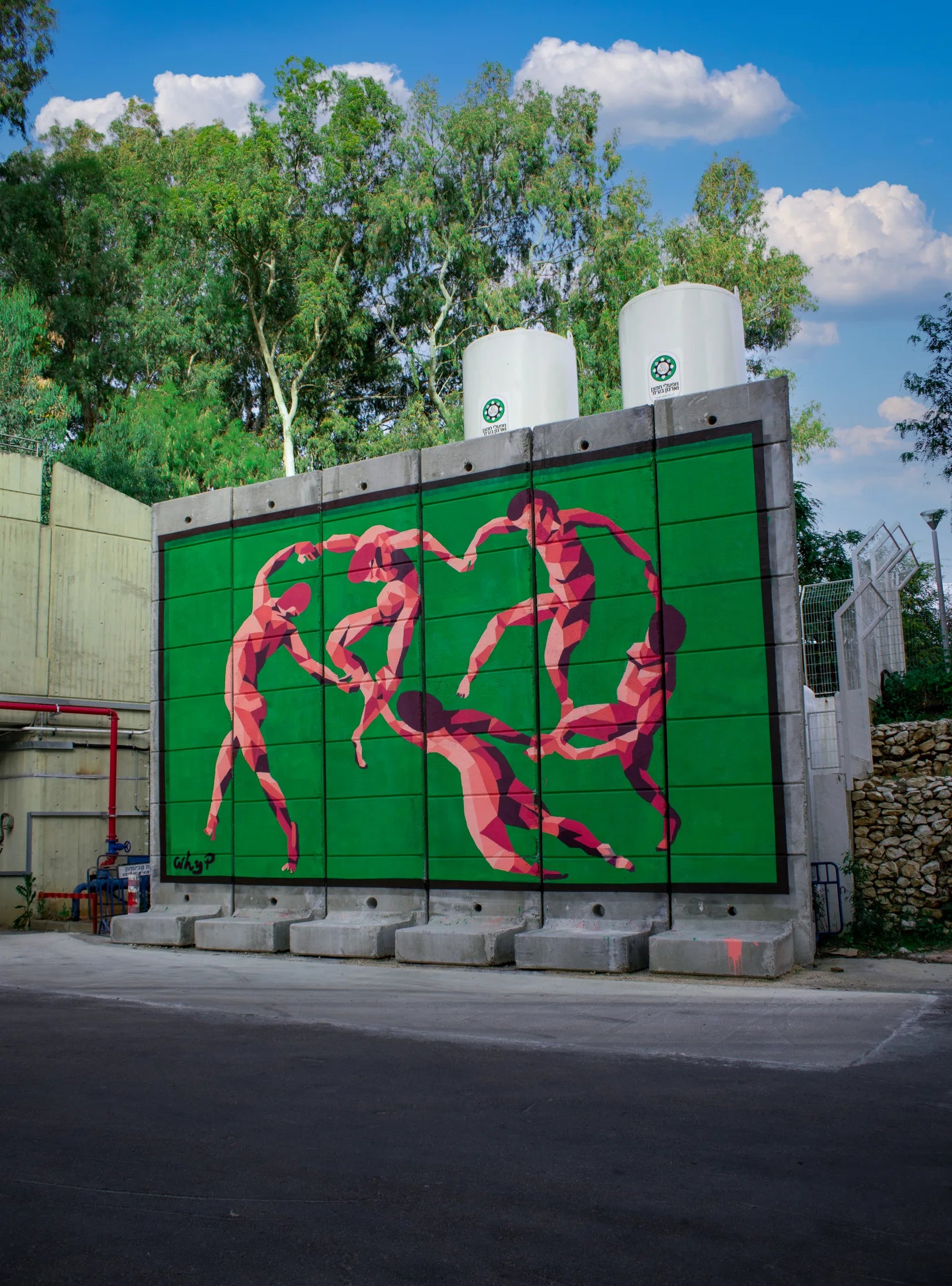 A monumental pink faceted-figure mural painted by WHYP on an industrial wall