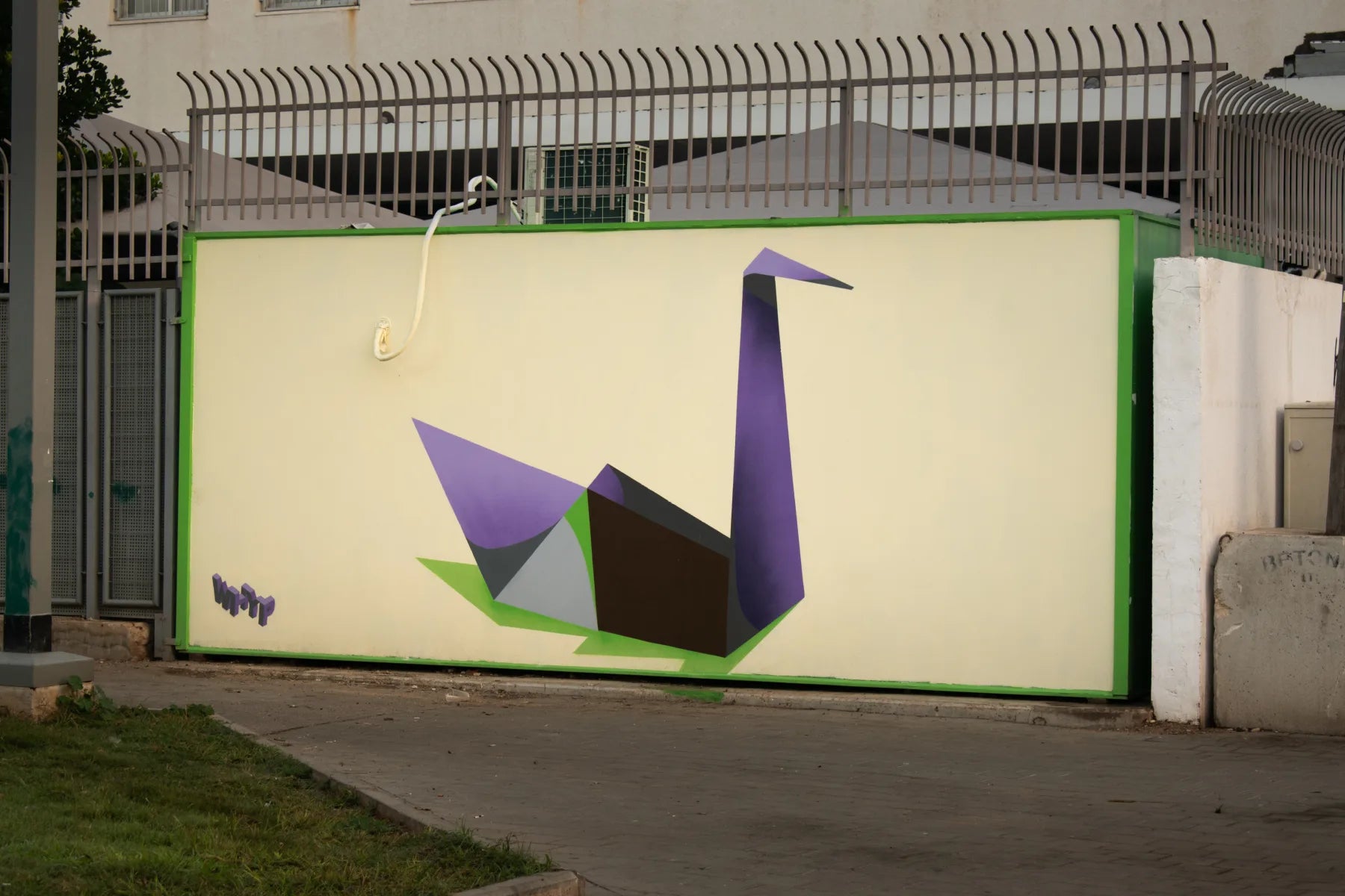Geometric swan mural on a pale exterior wall